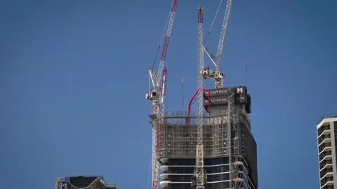 Close view of cranes on a construction site on the Esplanade, Surfers Paradise. Video stock 332562692