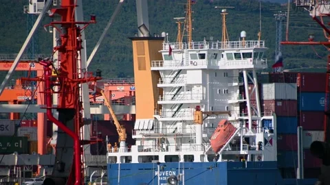 Close up view of cranes loading and unloading large ship carrier Stock Footage 161011480