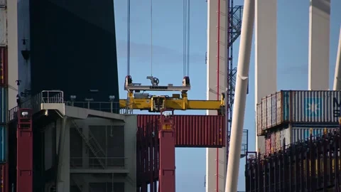 Close up view of cranes loading and unloading carrier ship Stock Footage 161012379