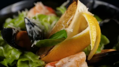 Close-up view of creamy green pasta, served with shrimps, mussels, parmesan Stock Footage 80797425