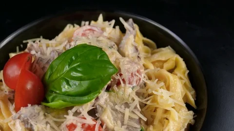 Close-up view of creamy pasta with meat, served with parmesan cheese Stock Footage 80708612