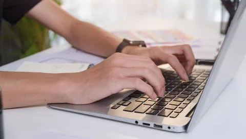 Close up view of creative man hands typing on laptop computer. Freelance wo.. Stock Photos