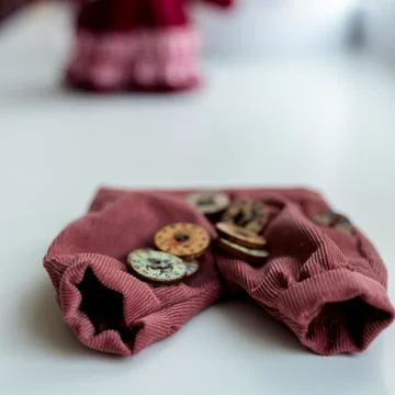 Close-up view on the creative process of sewing doll, details of doll cloth Stock Photos