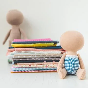 Close-up view on the creative process of sewing doll, details of doll cloth Stock Photos