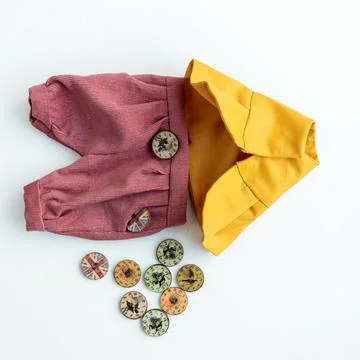 Close-up view on the creative process of sewing doll, details of doll cloth Stock Photos