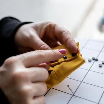 Close-up view on the creative process of sewing doll, details of doll cloth Stock Photos