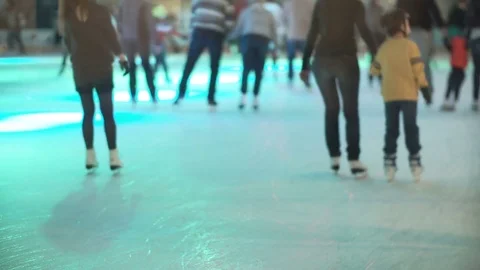 Close-up view of crowded place, young men and women skating together on the ice Stock Footage 80069350