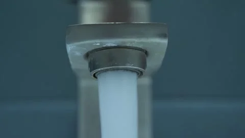 Close-Up View of Crystal Clear Water Flowing From a Modern Faucet Stock Footage 262667660