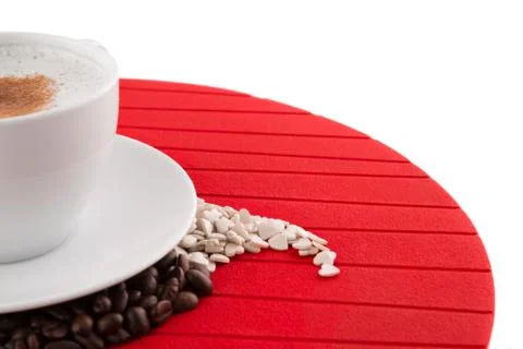 Close up view cup of coffee with coffee beans and candy assortment Stock Photos
