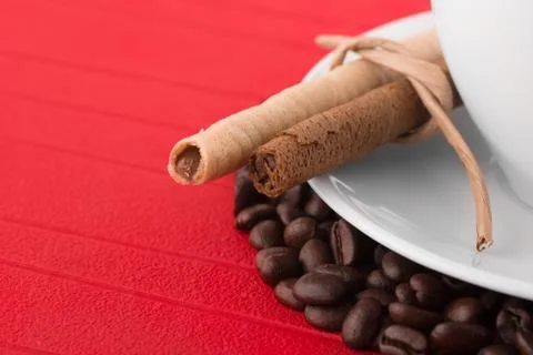 Close up view cup of coffee with coffee beans assortment Stock Photos