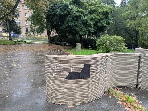 Close view of a curved 3D-printed concrete wall with layered extrusion texture Stock Photos