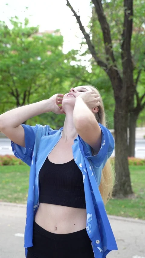 Close-up view of cute beautiful blonde girl on a walk through downtown at n.. Stock Footage 265003364