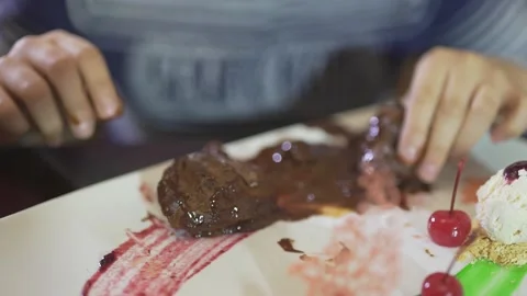 Close up view on cute little boy eating chocolate dessert with dirty hands messy Stock Footage 137538454