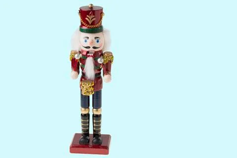 Close up view of cute Nutcracker figure on blue background. Stock Photos