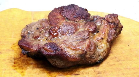 Close-up view of cutting a piece of roasted meat on a wooden board Stock-Footage 61215460