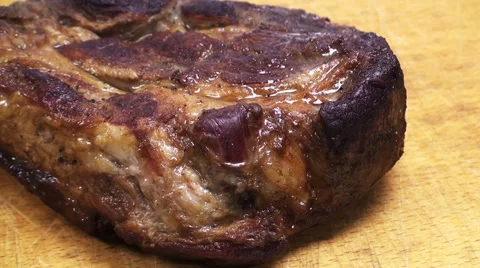 Close-up view of cutting a piece of roasted meat on a wooden board Stock Footage 61219594