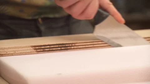 A close-up view of cutting poly foam for seats and cushions Stock Footage 103369176