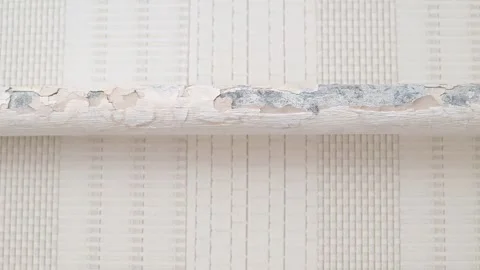A close-up view of a damaged surface with peeling paint and signs of wear. 库存影片 337101413