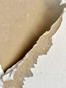 Close up view of damaged white drywall wall surface with peeling paper layer Stock Photos