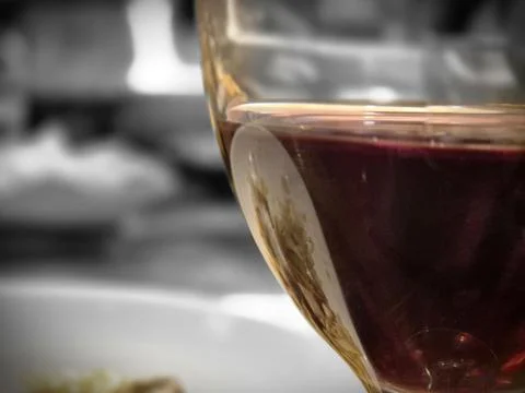 A close up view of dark coffee in a transparent glass cup with a softly blurr 写真素材