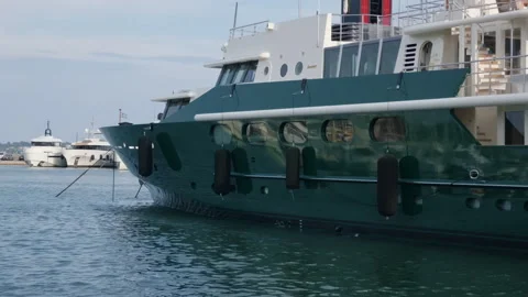 Close view of a dark green explorer-style superyacht docked in a marina, Stock Footage 344816759
