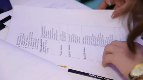 Close view dark haired administrator checks guest list Stock Footage 97096710