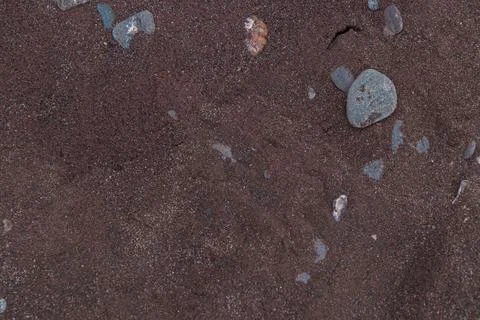 Close-up view of the dark iron sand on the unique beach of Jussaro Island, .. Foto stock