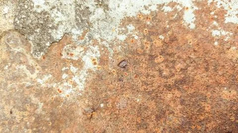 Close-up view of dark rust covering aged metal sheet. Grunge surface with o.. Stock Photos