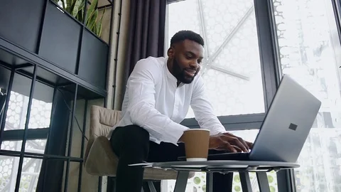Close view of dark-skinned young high-spirited bearded businessman which working Stock Footage 118080708