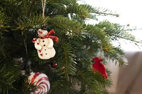 Close-up view of a decorated Christmas tree background with the cute snowma.. Stock Photos