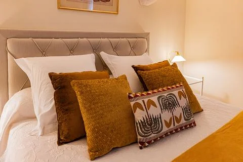 Close view of decorative cushions on a double bed at Chateau de Ribourdin, .. Stock Photos
