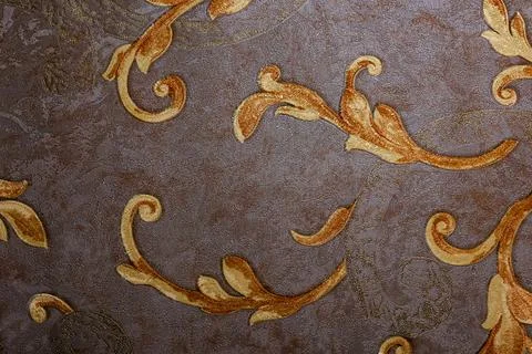 Close-up view of decorative fabric surface with ornate golden and brown floral Stock Photos