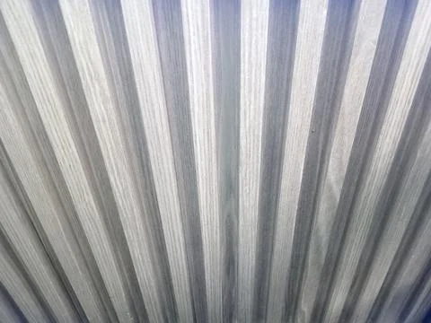 Close up view of decorative wall surface featuring repeating vertical wave .. Stock Photos
