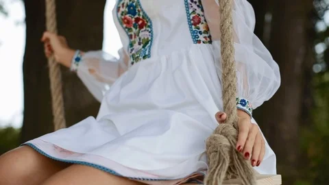 Close up view of delicate female legs covered with a light white dress while Video stock 87576407
