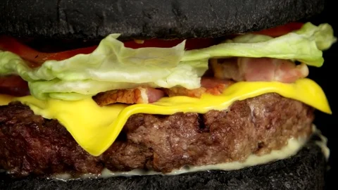Close-up view of delicious black burger with grilled meat Stock Footage 75253806