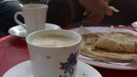 A close-up view of a delicious breakfast showcasing paratha and tea at a 스톡 동영상 291838456