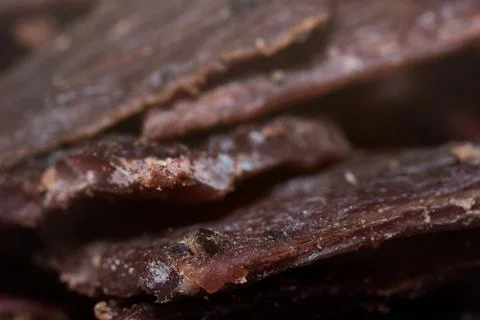 Close-up view of delicious cured beef jerky slices stacked together as a ta.. Stock Photos