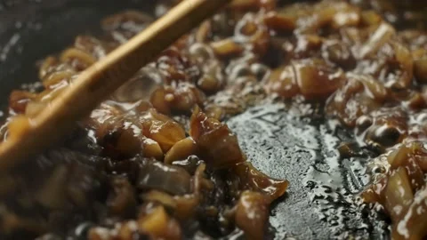 Close-up view of delicious onion roasting and caramelizing on pan Stock Footage 233845666
