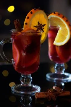 Close view on delicious winter mulled wine with oranges at romantic fireplace Stock Photos