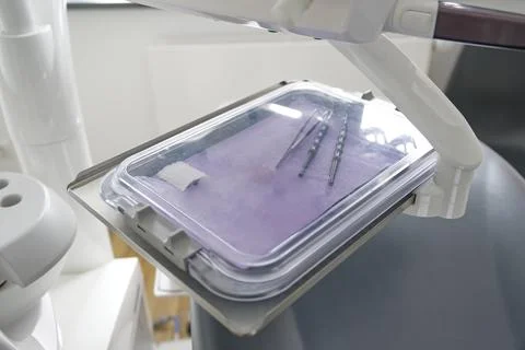 A close-up view of dental instruments placed on a sterile tray in a dental .. Stock Photos