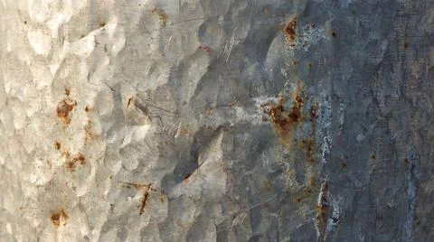 Close up view of dented silver metal plate with visible orange rust spots a.. Stock Illustration