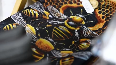 Close-up view of a designer bee patterned tie with honeycomb motifs Stock Footage 339754760