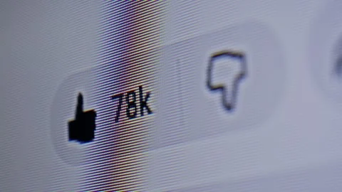 Close view of a device display as a user presses the like button on content. Stock Footage 336385232