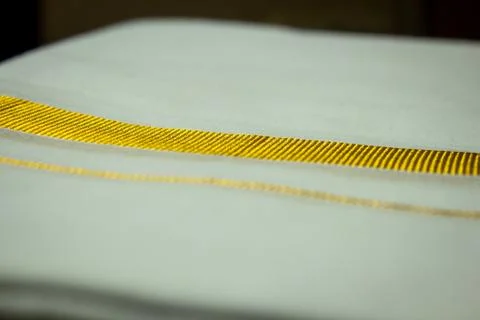 Close view of the dhoti with gold threaded border. Stock Photos