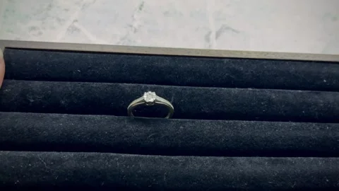 Close-up view of a diamond engagement ring on a black velvet display Stock Footage 336311637