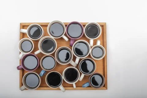Close up view of different cups of coffee on woodeen tray on white background Stock Photos