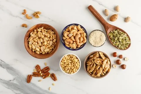 Close-up view of different types of nuts in bowls Stock Photos