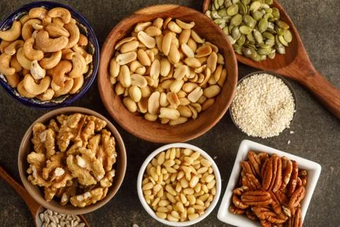 Close-up view of different types of nuts in bowls Stock Photos