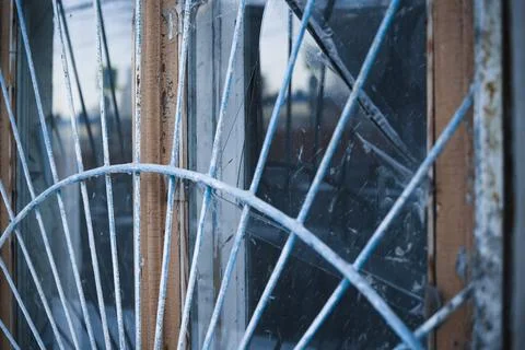 Close up view of dirty old window with iron bars Stock Photos