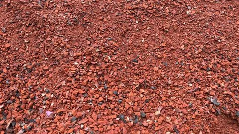 Up-close view displays reddish broken bricks that are coarsely textured, crea Foto stock